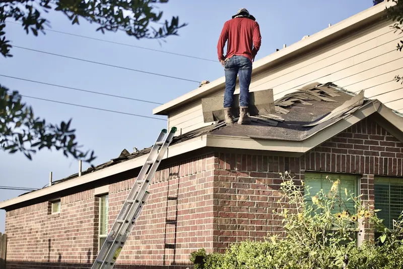Professional roofer working on a residential roof in Downtown Olympia